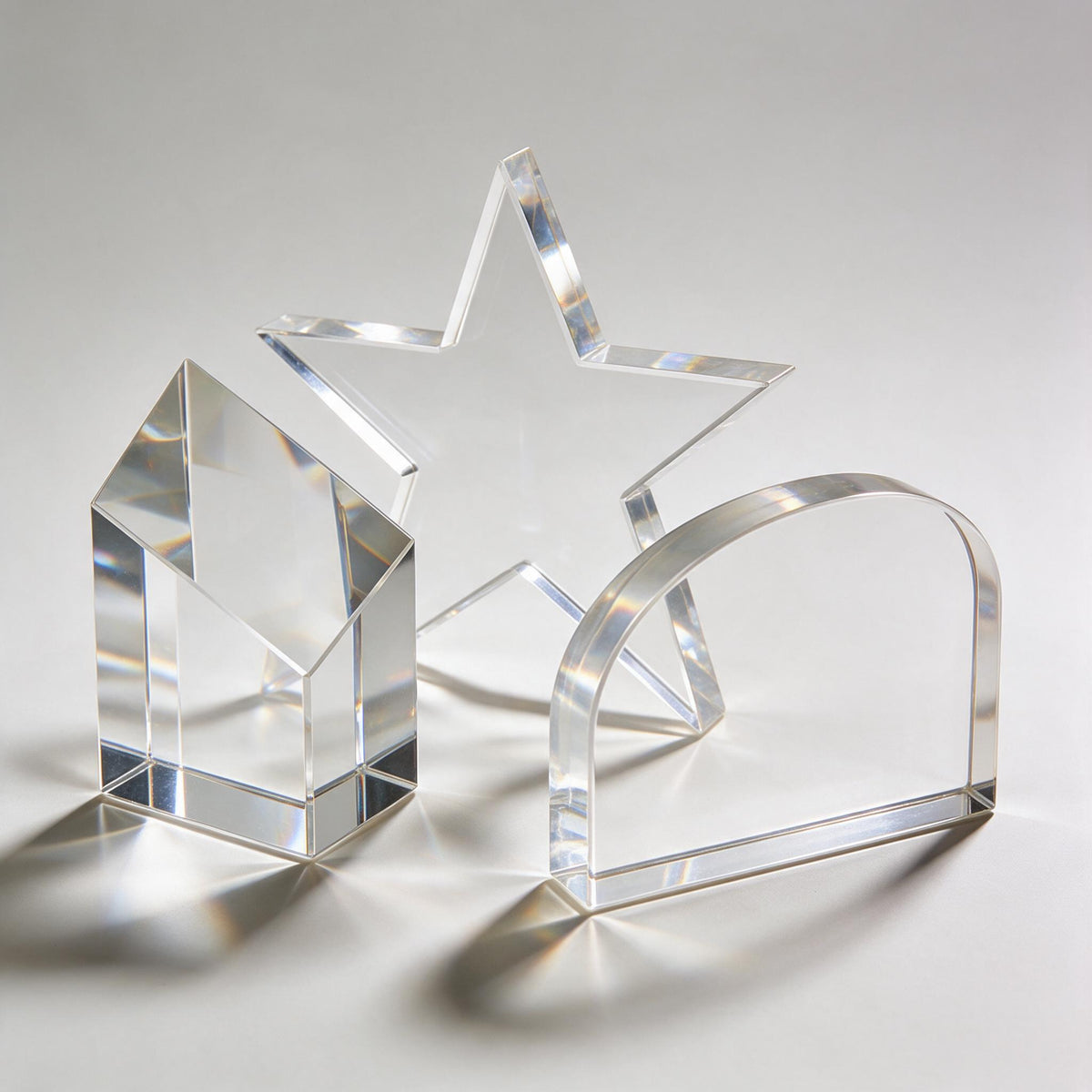 Clear acrylic and crystal awards including faceted block, star and desk plaque