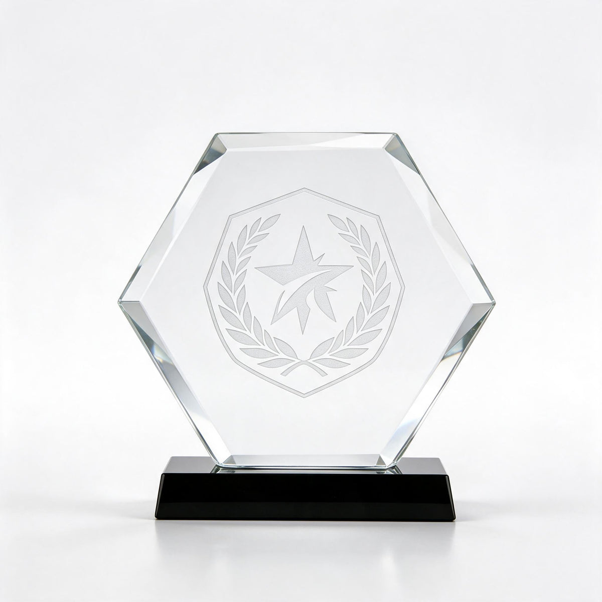 Clear crystal hexagon award with laser-engraved crest, on a black crystal base